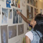 Christina and her classmates admire UM student art in Peterson Hall